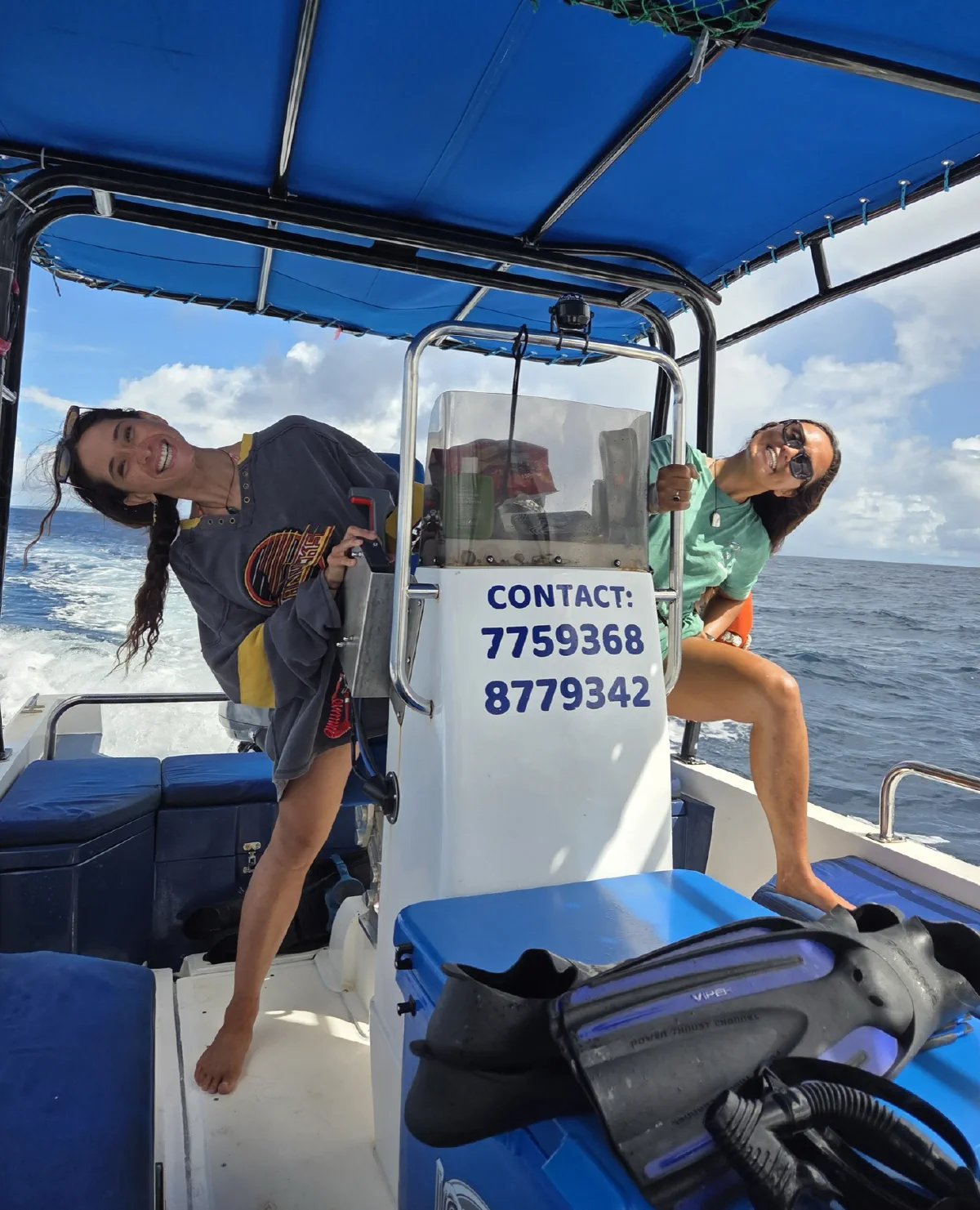 Hannah and Tee grinning around the boat's console